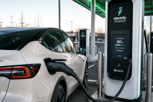 Electric vehicle using NACS charging connector at modern fast charging station